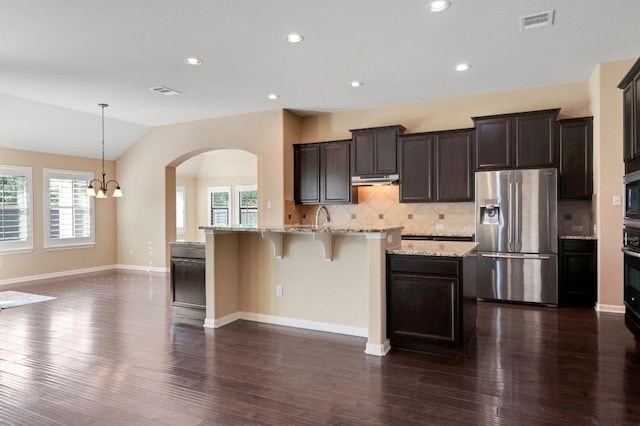 20125 Chayton Cir, Pflugerville, TX 78660 - kitchen featuring stainless steel fridge with ice dispenser, plenty of natural light, tasteful backsplash, dark wood-style flooring, and lofted ceiling