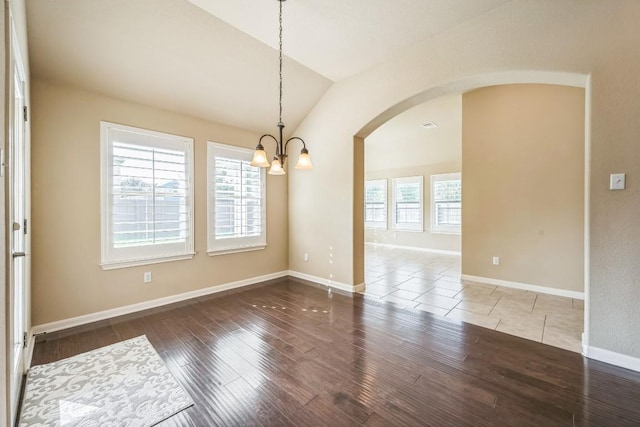 20125 Chayton Cir, Pflugerville, TX 78660 - unfurnished room featuring arched walkways, vaulted ceiling, a chandelier, wood-type flooring, and baseboards