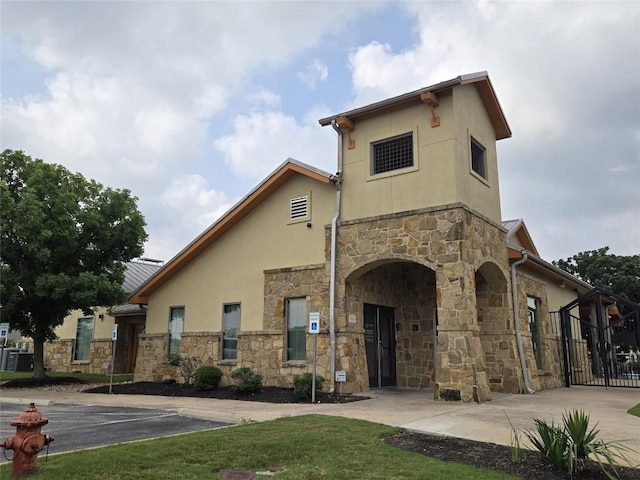 20125 Chayton Cir, Pflugerville, TX 78660 - view of front of house with stone siding, stucco siding, and uncovered parking