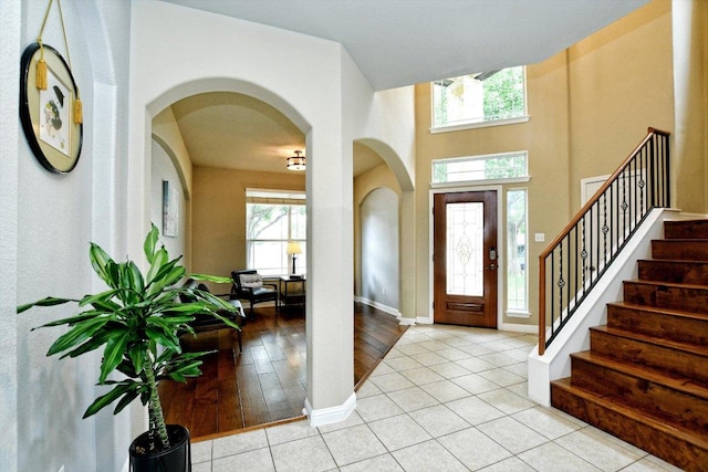 2807 Checker Dr, Cedar Park, TX 78613 - foyer featuring arched walkways, stairs, baseboards, and light tile patterned floors