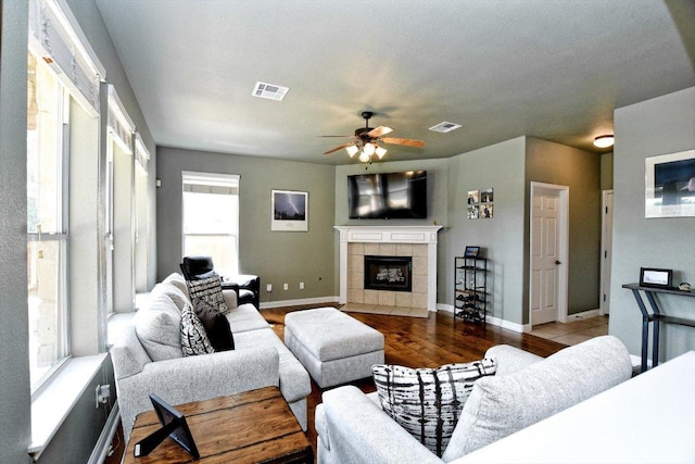 2807 Checker Dr, Cedar Park, TX 78613 - living room featuring ceiling fan, a tile fireplace, wood finished floors, and baseboards