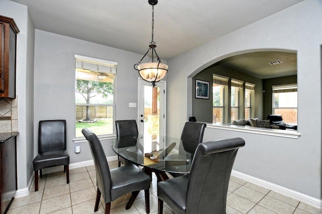 2807 Checker Dr, Cedar Park, TX 78613 - dining area with arched walkways, baseboards, and light tile patterned floors