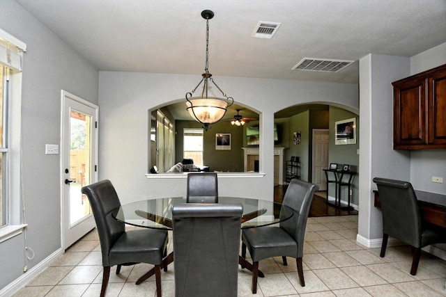 2807 Checker Dr, Cedar Park, TX 78613 - dining room featuring arched walkways, light tile patterned floors, and ceiling fan