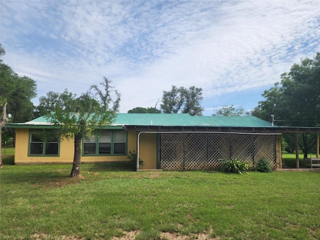 515 Country Ln, Buda, TX 78610 - back of house with a yard and metal roof