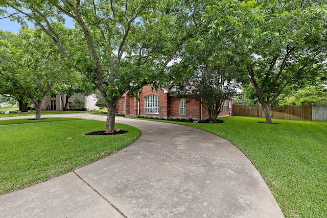 11 Meadow Run, Round Rock, TX 78664 - obstructed view of property with curved driveway and brick siding