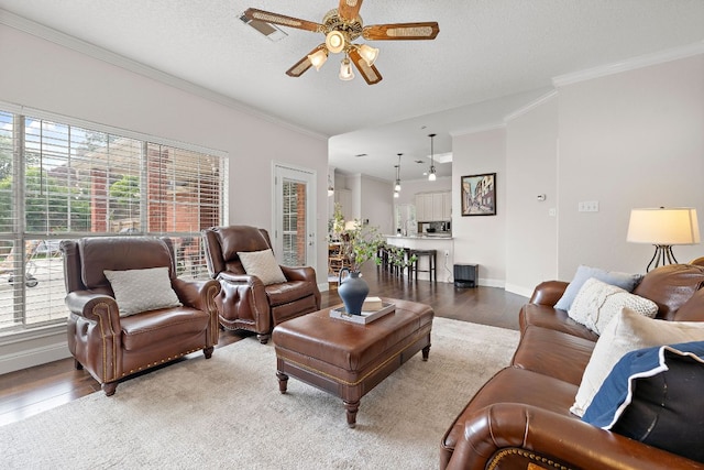 11 Meadow Run, Round Rock, TX 78664 - living area with a ceiling fan, ornamental molding, light wood-type flooring, and baseboards
