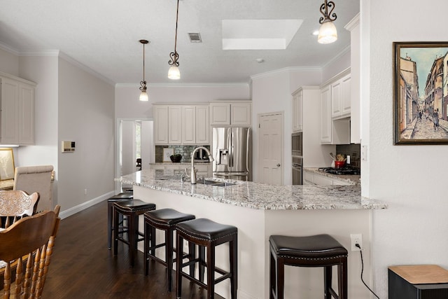 11 Meadow Run, Round Rock, TX 78664 - kitchen with stainless steel refrigerator with ice dispenser, a sink, decorative backsplash, a skylight, and dark wood-style floors