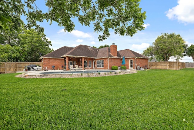 11 Meadow Run, Round Rock, TX 78664 - back of house with brick siding, a chimney, a patio, and a shingled roof