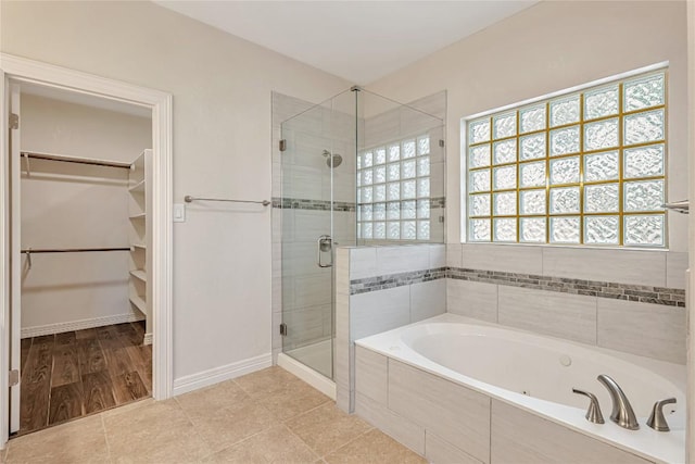 9010 Bluegrass Dr, Austin, TX 78759 - full bath featuring a shower stall, a spacious closet, and a bath