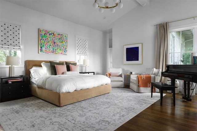 102 Crestwood Ct, Austin, TX 78746 - bedroom with multiple windows, wood finished floors, vaulted ceiling, and a chandelier
