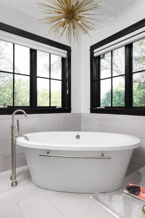 102 Crestwood Ct, Austin, TX 78746 - bathroom featuring tile walls, tile patterned floors, a freestanding bath, and a chandelier