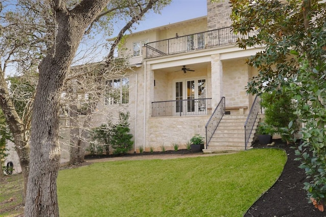 102 Crestwood Ct, Austin, TX 78746 - view of front of home with a balcony, a front lawn, stucco siding, and stairs