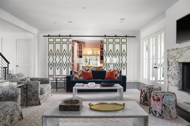 102 Crestwood Ct, Austin, TX 78746 - living room featuring a barn door, healthy amount of natural light, and ornamental molding
