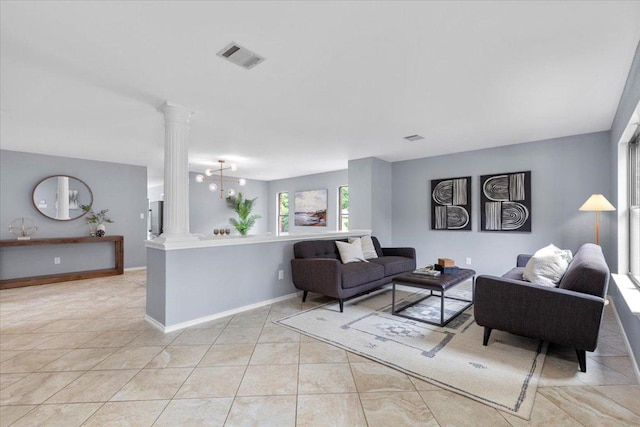 1222 Minerva St, Austin, TX 78753 - living area featuring decorative columns, light tile patterned floors, and baseboards