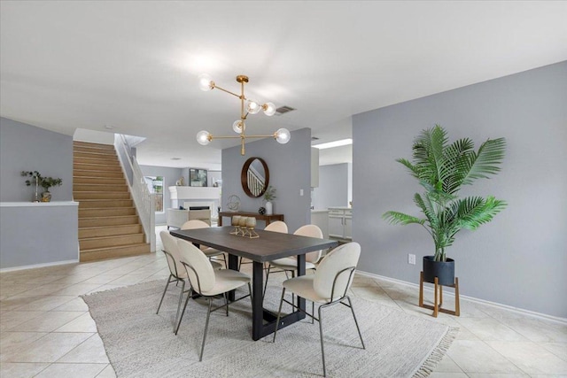 1222 Minerva St, Austin, TX 78753 - dining area featuring light tile patterned floors, stairway, baseboards, and a chandelier