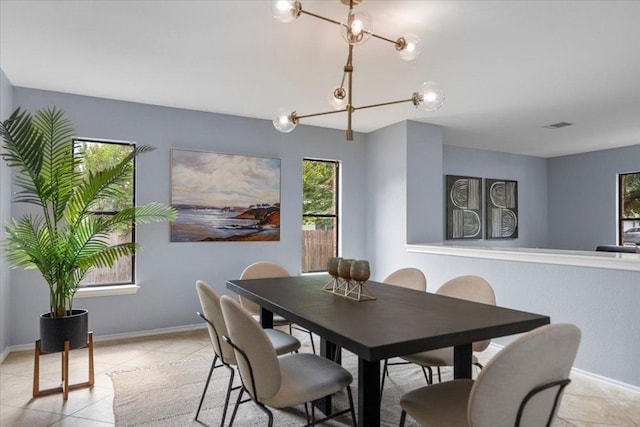1222 Minerva St, Austin, TX 78753 - dining space featuring light tile patterned floors, a chandelier, and baseboards