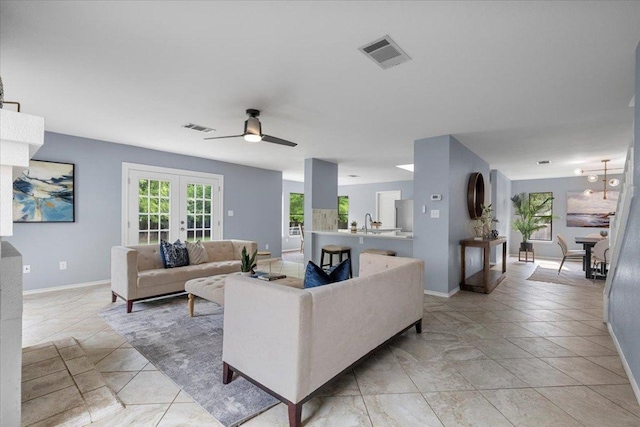 1222 Minerva St, Austin, TX 78753 - living room featuring ceiling fan, baseboards, french doors, and light tile patterned floors
