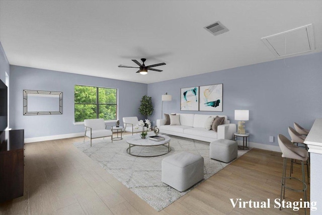 1222 Minerva St, Austin, TX 78753 - living room with attic access, wood finished floors, ceiling fan, and baseboards