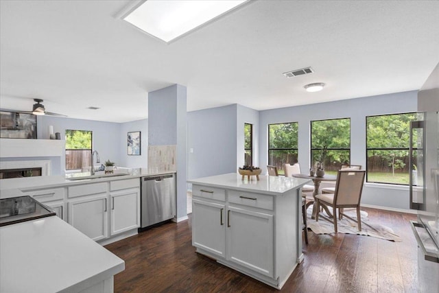 1222 Minerva St, Austin, TX 78753 - kitchen with dishwasher, dark wood finished floors, and light countertops