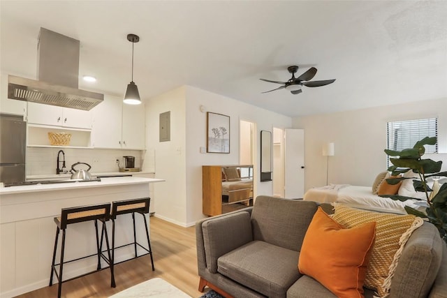 2000 Glen Allen St Unit 2, Austin, TX 78704 - living area featuring light wood-style floors, a ceiling fan, and baseboards