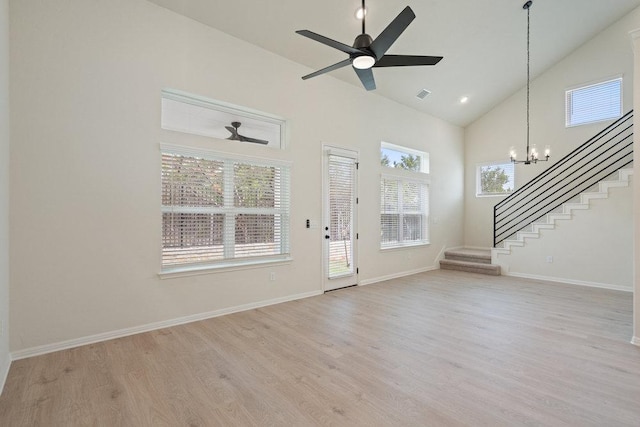 2008 Kit Cir, Austin, TX 78758 - entryway featuring stairs, light wood-style flooring, high vaulted ceiling, a chandelier, and baseboards