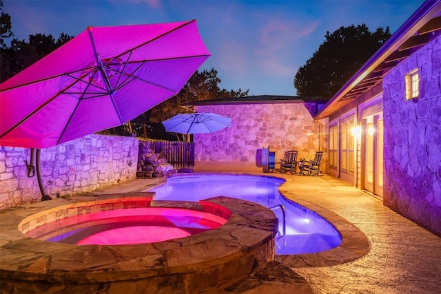 4671 Fischer Store Rd, Wimberley, TX 78676 - view of swimming pool featuring a patio area, a pool with connected hot tub, and a fenced backyard