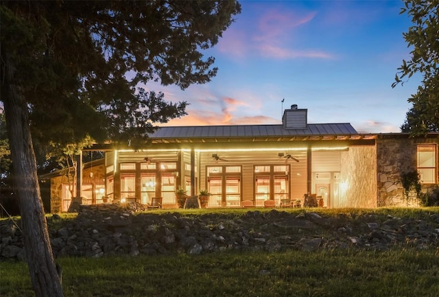 4671 Fischer Store Rd, Wimberley, TX 78676 - rear view of property featuring a ceiling fan, a chimney, a standing seam roof, metal roof, and stone siding