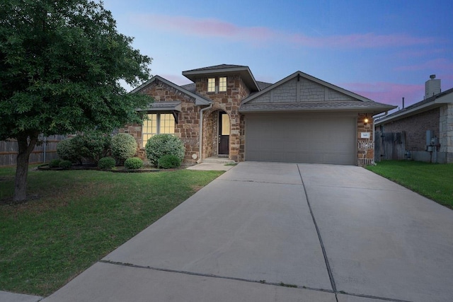 140 W Highfield St, Hutto, TX 78634 - view of front of property with stone siding, a garage, and concrete driveway