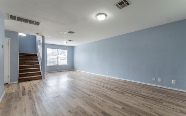 3907 Sojourner St, Austin, TX 78725 - empty room featuring wood finished floors, stairs, and baseboards
