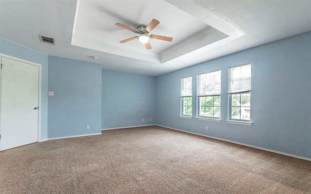 3907 Sojourner St, Austin, TX 78725 - carpeted spare room featuring a raised ceiling, ceiling fan, baseboards, and crown molding