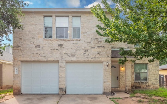 3907 Sojourner St, Austin, TX 78725 - view of property featuring a garage, driveway, and stone siding