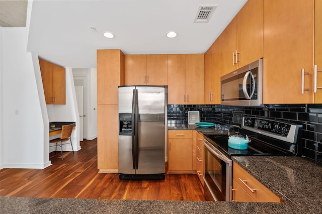 360 Nueces St Unit 1407, Austin, TX 78701 - kitchen featuring appliances with stainless steel finishes, dark wood-style floors, tasteful backsplash, baseboards, and dark stone countertops
