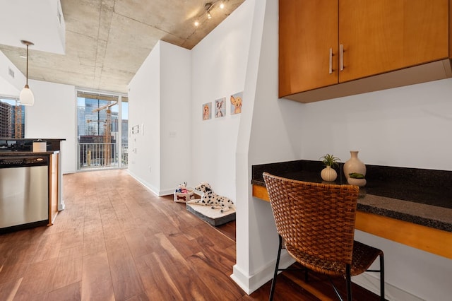 360 Nueces St Unit 1407, Austin, TX 78701 - kitchen featuring dishwasher, wood finished floors, dark countertops, baseboards, and pendant lighting