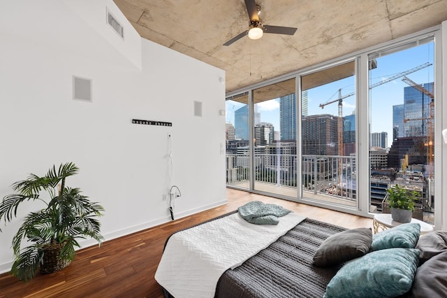 360 Nueces St Unit 1407, Austin, TX 78701 - bedroom featuring wood finished floors, access to outside, a skyline view, multiple windows, and a wall of windows