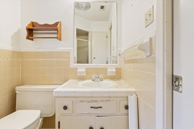 4412 Briar Cliff Rd, Temple, TX 76502 - full bath with tile walls, a shower stall, toilet, and vanity