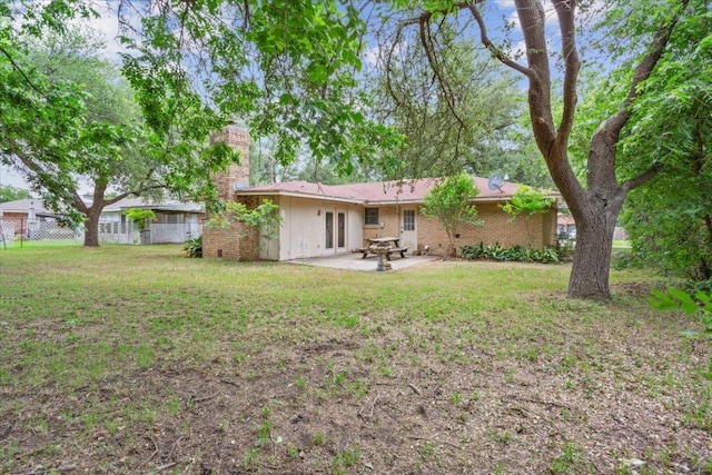 4412 Briar Cliff Rd, Temple, TX 76502 - rear view of property featuring a chimney, a patio area, and french doors