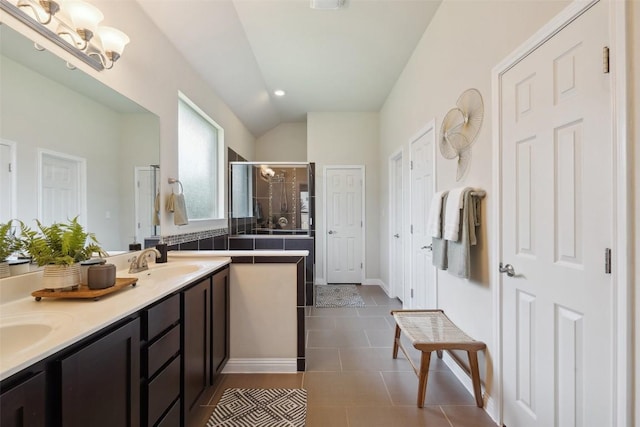 2944 Castellan Ln, Round Rock, TX 78665 - bathroom with a shower stall, double vanity, tile patterned floors, and vaulted ceiling