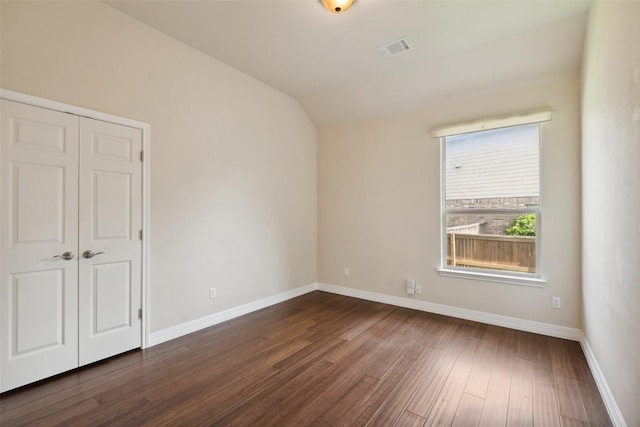 2944 Castellan Ln, Round Rock, TX 78665 - unfurnished bedroom featuring lofted ceiling, dark wood finished floors, and a closet