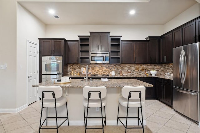 2944 Castellan Ln, Round Rock, TX 78665 - kitchen featuring stainless steel appliances, open shelves, decorative backsplash, light stone countertops, and light tile patterned floors