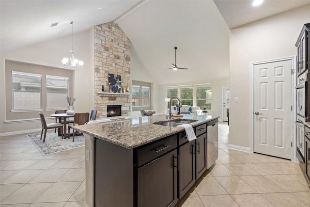 2944 Castellan Ln, Round Rock, TX 78665 - kitchen with a fireplace, high vaulted ceiling, light tile patterned floors, a ceiling fan, and open floor plan