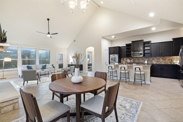 2944 Castellan Ln, Round Rock, TX 78665 - dining space featuring arched walkways, high vaulted ceiling, ceiling fan, light tile patterned flooring, and recessed lighting