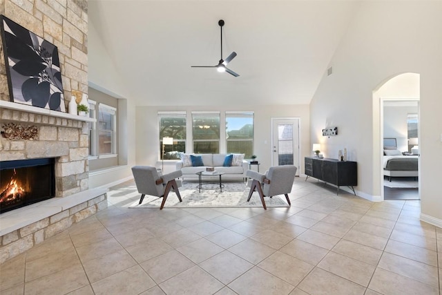 2944 Castellan Ln, Round Rock, TX 78665 - living room featuring high vaulted ceiling, ceiling fan, a fireplace, light tile patterned flooring, and arched walkways