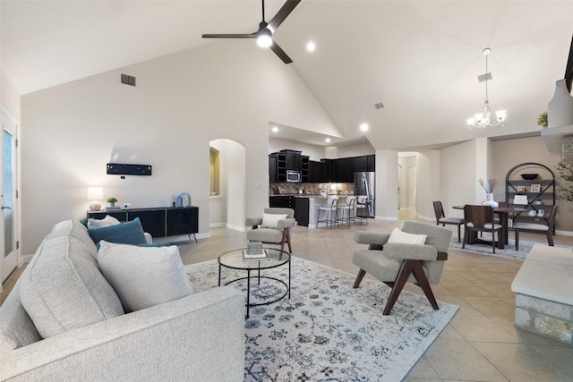 2944 Castellan Ln, Round Rock, TX 78665 - living area featuring high vaulted ceiling, a chandelier, arched walkways, a ceiling fan, and light tile patterned flooring