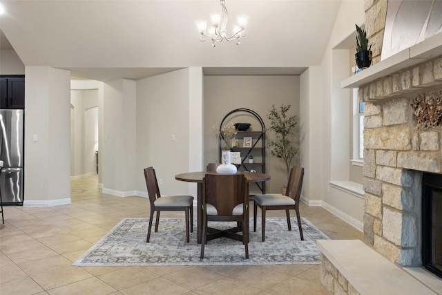 2944 Castellan Ln, Round Rock, TX 78665 - dining room featuring a chandelier, light tile patterned floors, and a stone fireplace