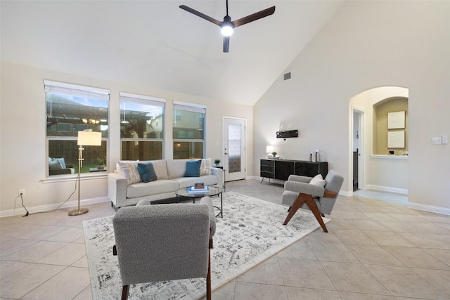 2944 Castellan Ln, Round Rock, TX 78665 - living room featuring light tile patterned floors, a ceiling fan, high vaulted ceiling, and arched walkways