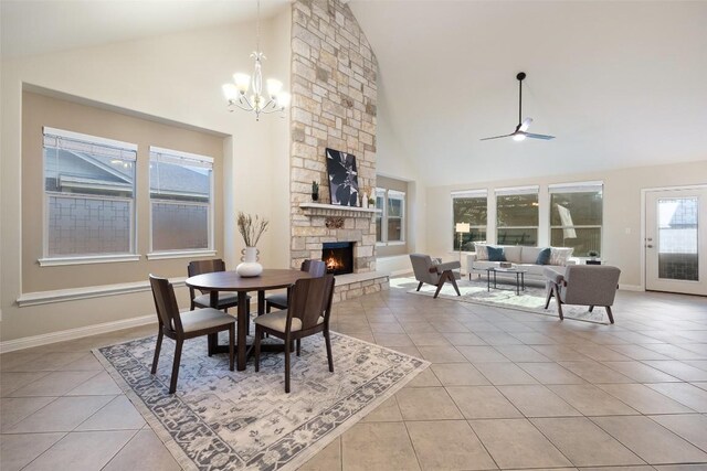 2944 Castellan Ln, Round Rock, TX 78665 - dining area with a fireplace, light tile patterned floors, a chandelier, high vaulted ceiling, and ceiling fan