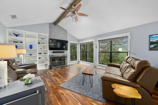 2009 S Oak Canyon Rd, Austin, TX 78746 - living area featuring wood finished floors, a ceiling fan, a fireplace with flush hearth, and a textured ceiling