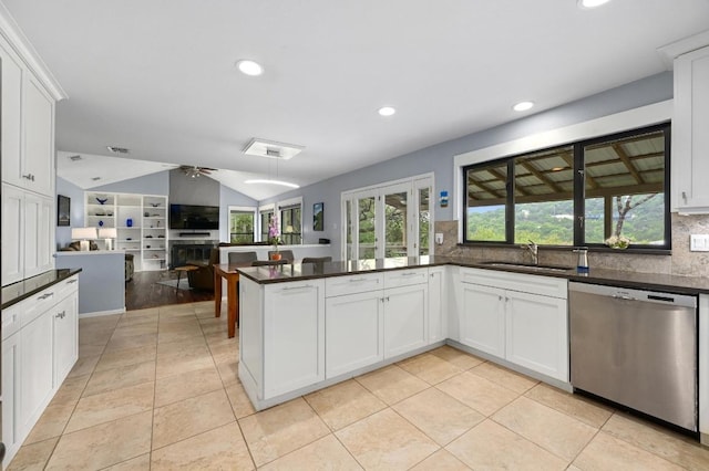 2009 S Oak Canyon Rd, Austin, TX 78746 - kitchen featuring stainless steel dishwasher, a sink, lofted ceiling, decorative backsplash, and dark countertops