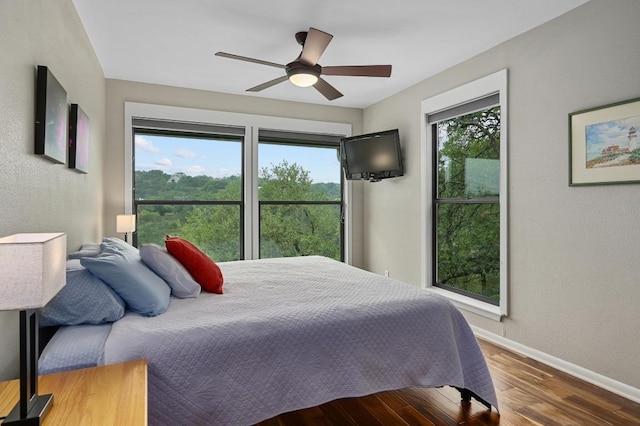 2009 S Oak Canyon Rd, Austin, TX 78746 - bedroom featuring wood finished floors, baseboards, and a ceiling fan