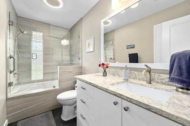 2009 S Oak Canyon Rd, Austin, TX 78746 - bathroom featuring tile patterned flooring, tiled shower / bath combo, toilet, and vanity